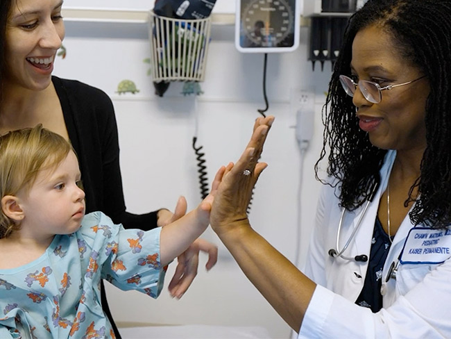 young girl giving high five to woman doctor